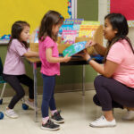 BBD01 HR ECE Bamboo Book Display on Table with 2 models and teacher